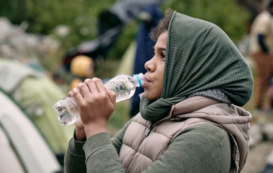 migrant girl drinking water